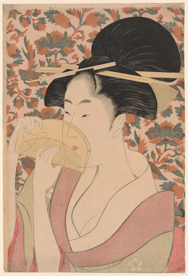 Utamaro woodblock print of a woman holding a tortoise-shell hair comb